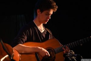 Laurence Frangos-Rhodes with his guitar.